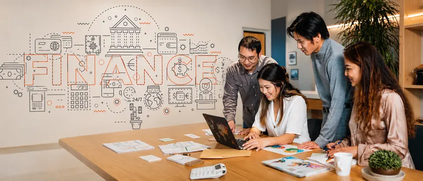 A finance team reviewing figures together beside a finance wall mural
