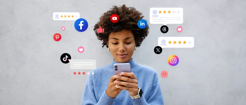 A person on a phone surrounded by social platform icons and reviews